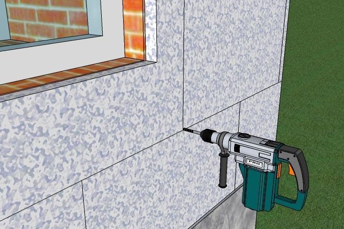 Після висихання клею встановлюємо пластикові дюбелі. Для цього свердлимо отвори перфоратором.